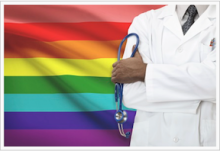 Doctor in front of a rainbow flag